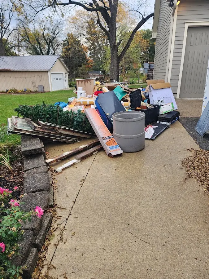 Dumpster being loaded with debris for Estate Cleanout Dumpster Rental in Metairie